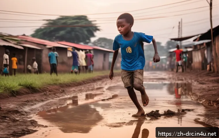 콩고의 스포츠 스타  축구 선수 - A young Congolese boy practicing football barefoot on a muddy street in Kinshasa at dusk, wearing si...